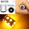 A close-up view of a BA15S single contact bayonet light bulb and an illuminated LED bulb.