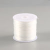 A spool of white elastic crystal beading cord for jewelry making.