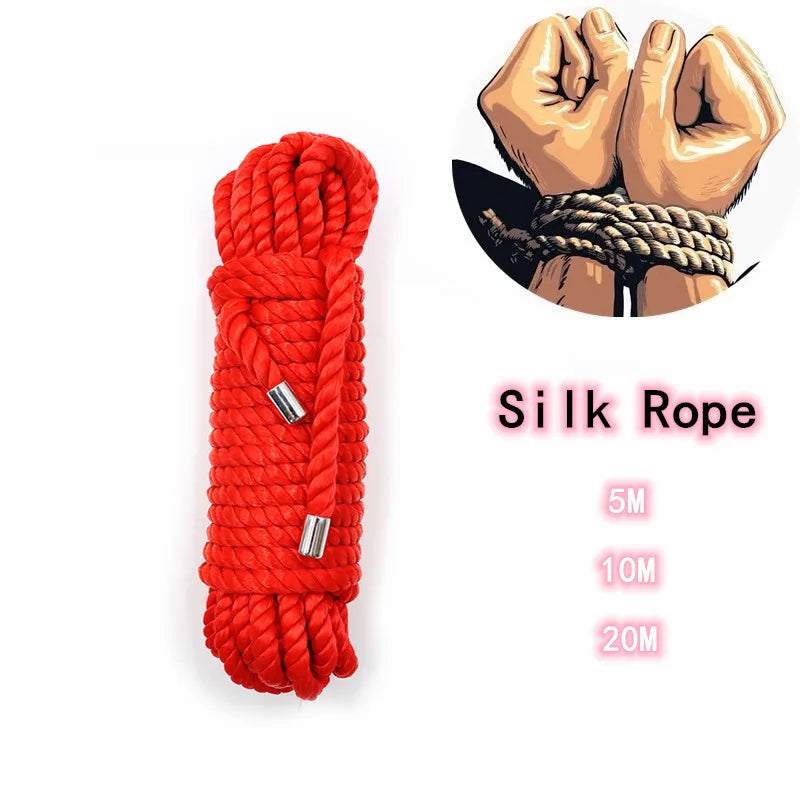 Red silk rope coiled and a hand wrapped in the same material