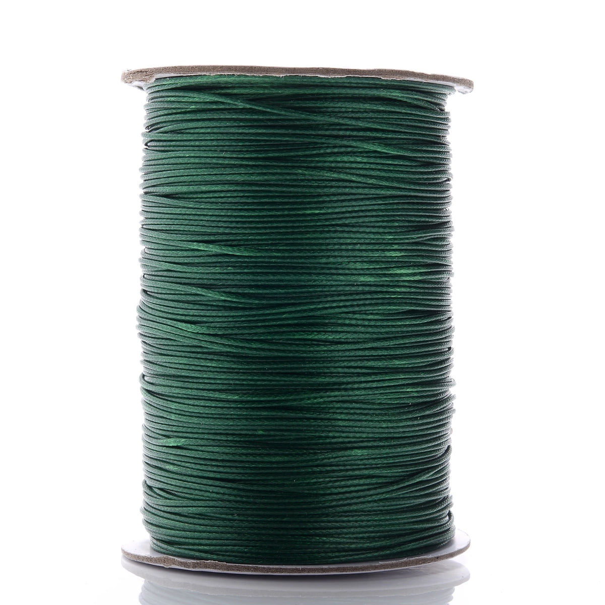 A spool of dark green waxed cotton cord used for jewelry making.