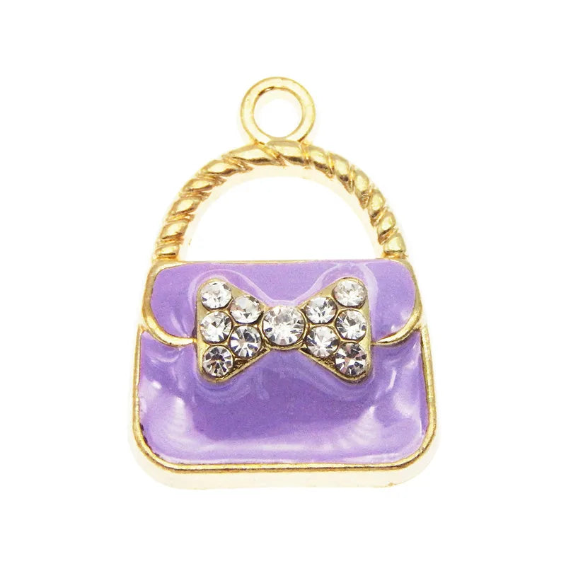 A set of six crystal enamel handbag charms with gold-toned loops and decorative elements.
