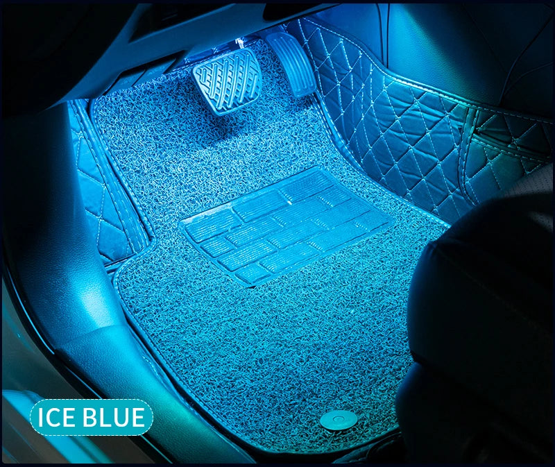 Ice blue ambient lighting illuminates the interior of a car with diamond-stitched upholstery and illuminated floor mats.