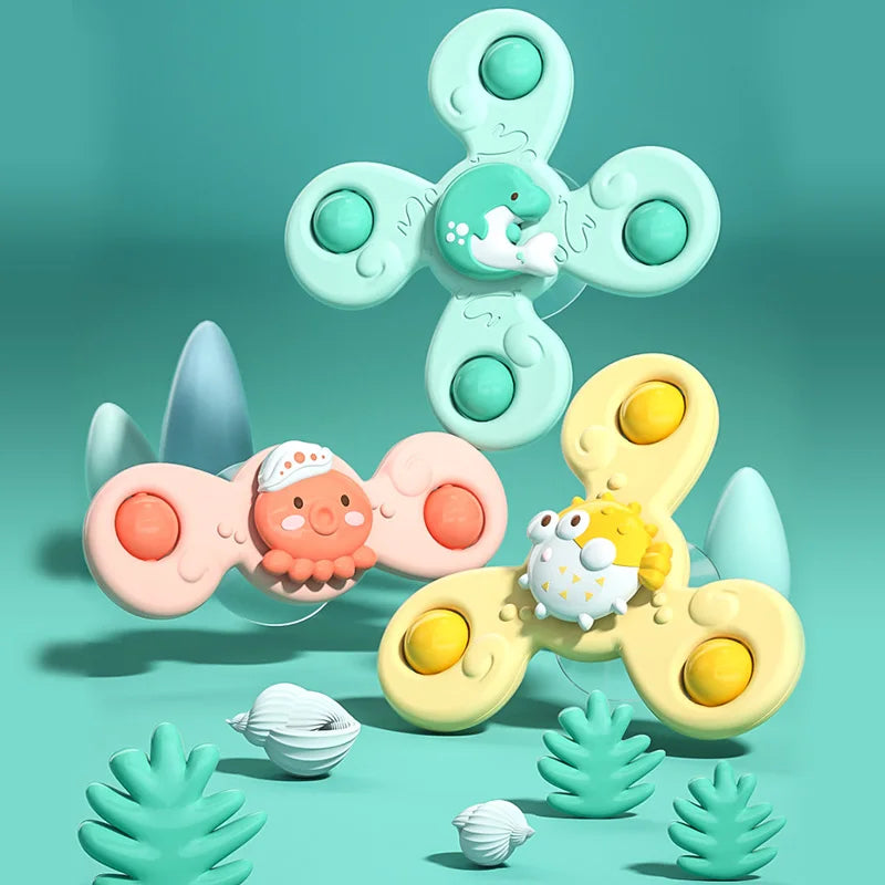 A colorful suction cup spinner bath toy featuring a light green and yellow design for toddlers.