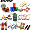 A set of 1/10 scale RC crawler decorations including a shovel, fire extinguisher, and oil drum.