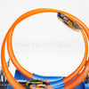 A simulation track set featuring an orange loop and dual-lane racing tracks with small cars.
