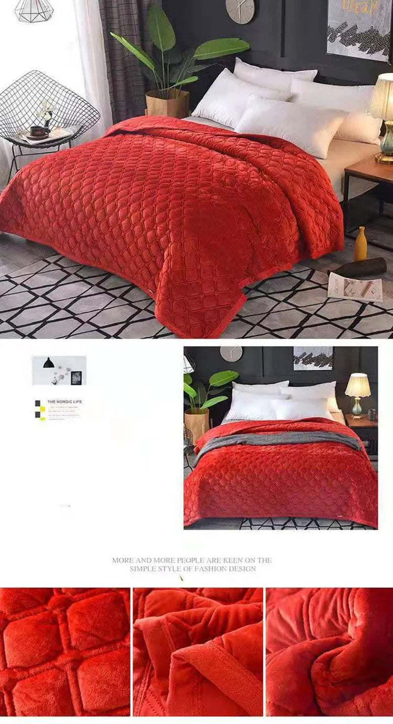 A close-up of a luxurious, thickened red velvet bedspread with a quilted pattern draped on a bed.
