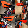 Close-up view of bright orange motorcycle handguards with black mounts and aluminum alloy components.
