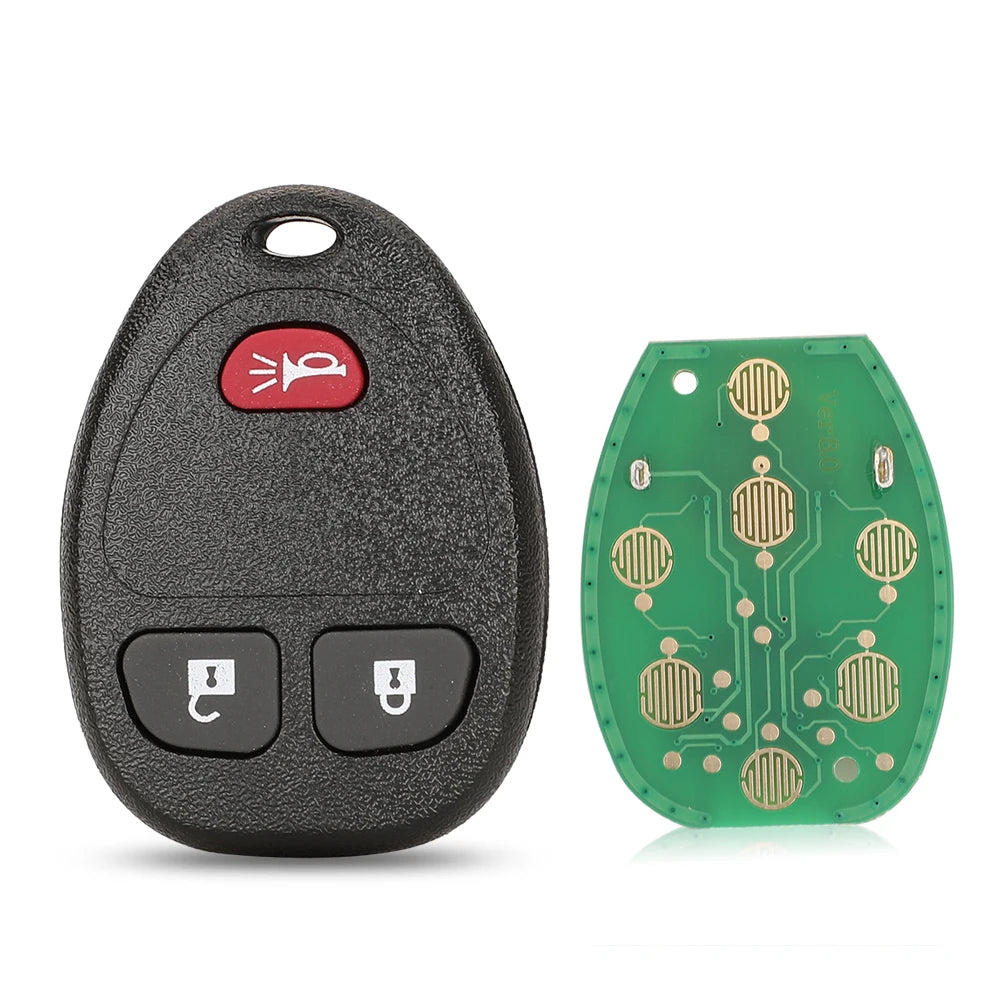 A black car key fob and a green circuit board with key blanks for replacement.
