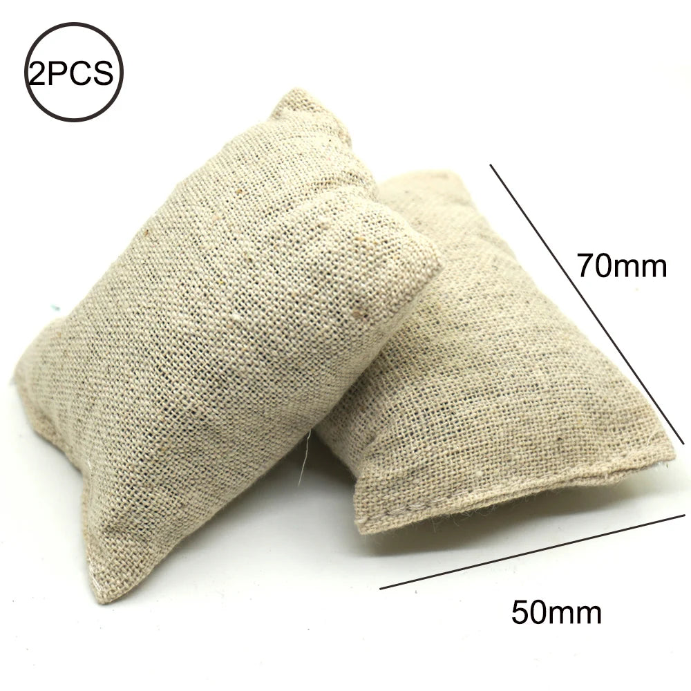 Two beige fabric items, likely a shovel and fire extinguisher, shown next to a measurement scale.