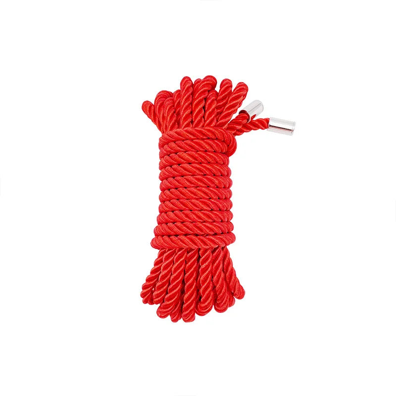 A bundle of bright red soft silk bondage rope coiled and tied together.