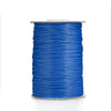 A spool of blue waxed cotton cord used for jewelry making.
