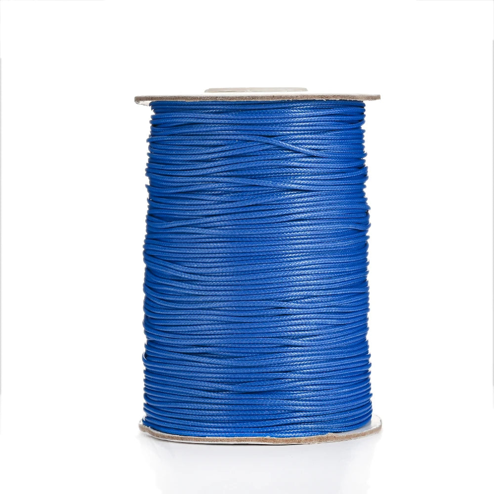 A spool of blue waxed cotton cord used for jewelry making.
