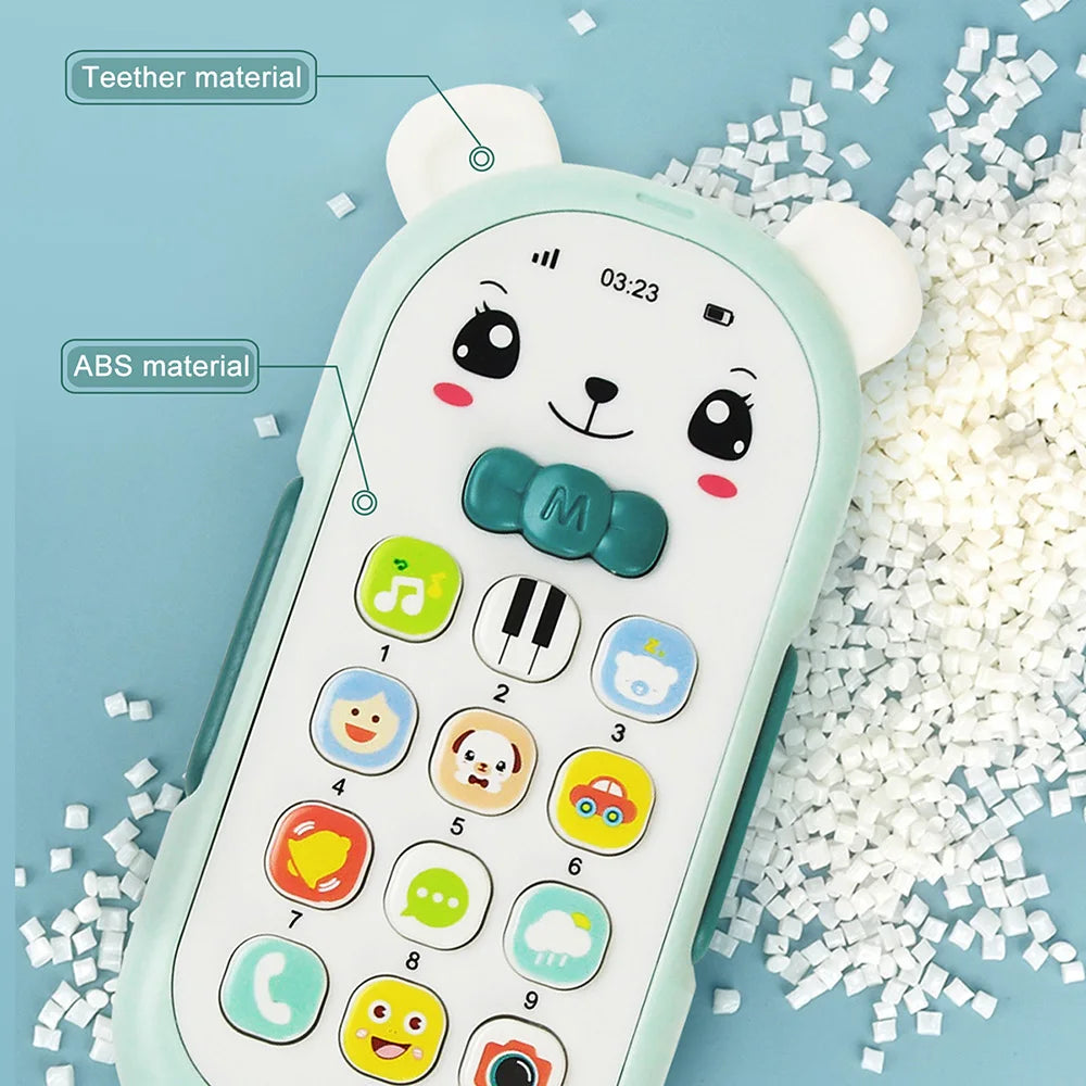 A light green musical teether phone toy featuring various buttons and a cute bear design, surrounded by small white pieces.