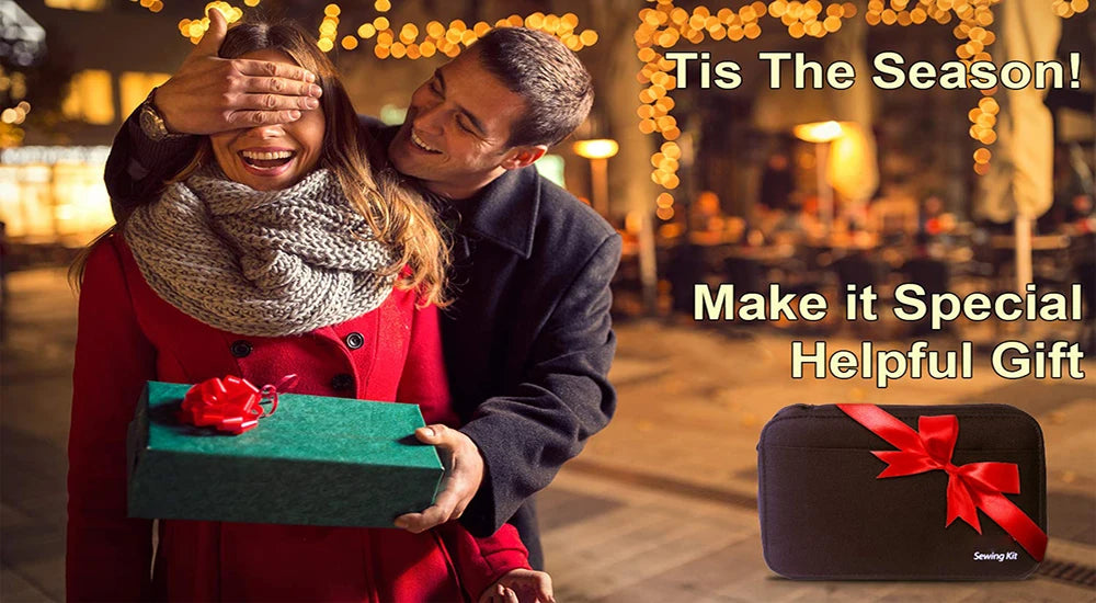 A couple smiling outdoors holding a green gift box and a black sewing kit storage bag.