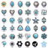 A collection of various decorative metal snap buttons and jewelry findings for crafting.