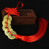 Chinese Feng Shui wealth coins strung together with a red handmade knot and tassel