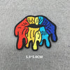 A set of five rainbow-colored embroidered iron-on patches shaped like stylized hands.