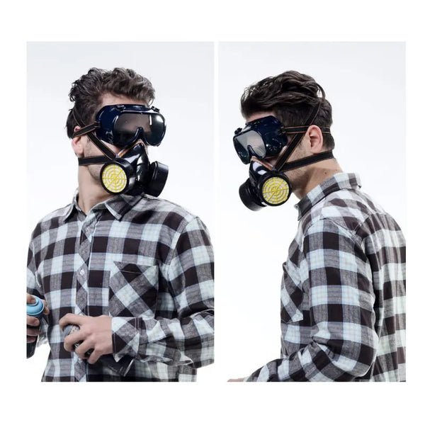 A man wearing a black half-face respirator with dual yellow organic vapor filters and a plaid shirt.