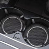 Close-up view of a black crystal rhinestone non-slip cup mat for cars with textured surfaces.