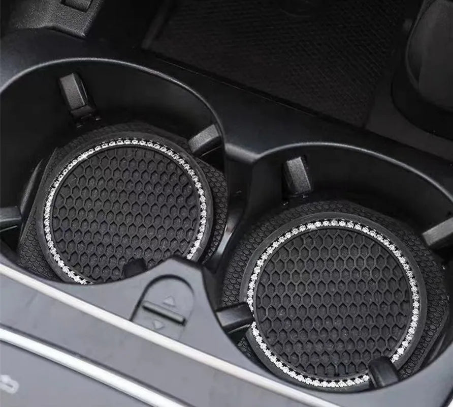 Close-up view of a black crystal rhinestone non-slip cup mat for cars with textured surfaces.
