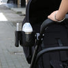 A black stroller features a mounted cup holder for drinks and a phone holder.