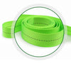 A close-up view of a roll of bright lime green heavy-duty tie-down straps with black dashed lines.