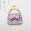 Gold-toned pendant featuring a lavender enamel handbag charm with a sparkling bow detail