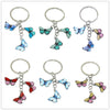 A set of colorful butterfly keychain charms with silver rings for bags and keys