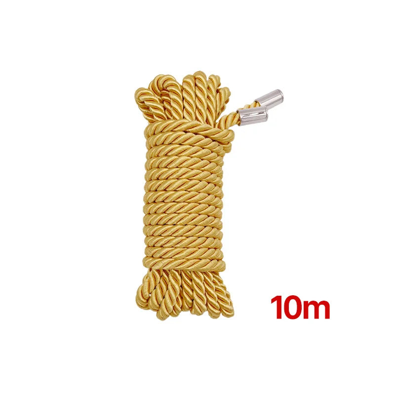 A spool of golden yellow soft silk bondage rope measuring 10 meters with a metal clip.