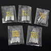 A collection of silver sewing machine needles packaged in clear plastic trays with various sizes and counts.