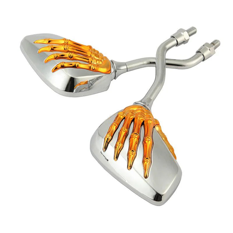 A pair of chrome motorcycle side mirrors featuring skull hand designs in gold color.