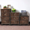 A rustic wooden dresser with drawers decorated with small plants and a framed picture.