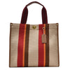 A beige canvas tote bag with vertical stripes of red, brown, and orange, featuring a leather strap.