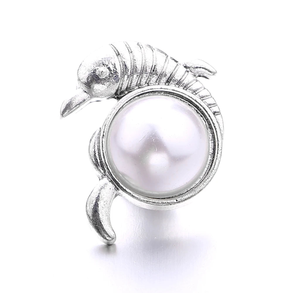 Silver metal snap button shaped like a tiny shrimp with a round pearl center for jewelry making