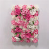 A wall panel featuring a dense arrangement of pink and white silk rose flowers for weddings and events.