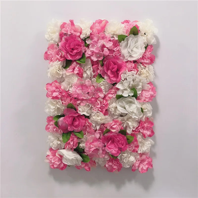 A wall panel featuring a dense arrangement of pink and white silk rose flowers for weddings and events.