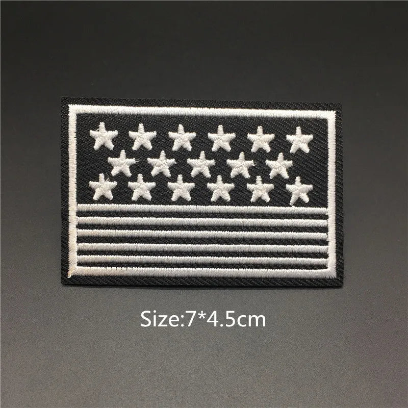 Black and white embroidered patch featuring stars and stripes design for clothing