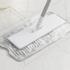 A white foldable silicone washboard with suction cups is shown on a white marble surface.