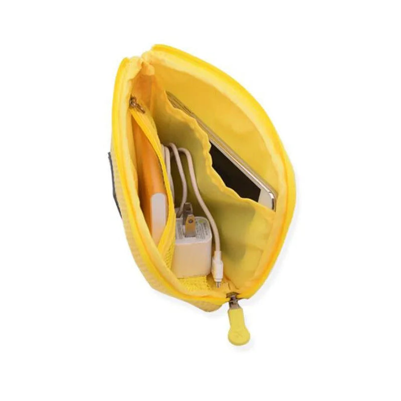 A yellow compact travel cable organizer bag with a zipper open, showing internal compartments for cables.