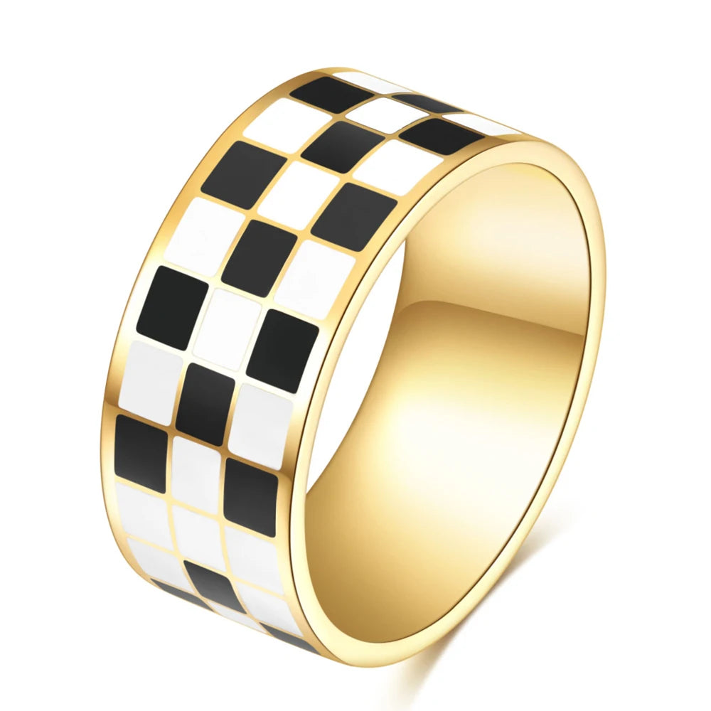 A chunky gold ring with a black and white checkerboard pattern.