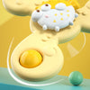 A yellow suction cup spinner bath toy with a white, face-like character and a green ball floating above a blue surface.