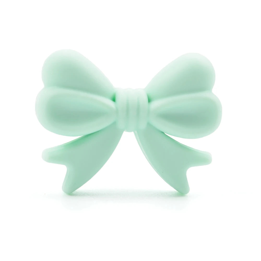 A light mint green food-grade silicone bow shaped crown bead for jewelry making
