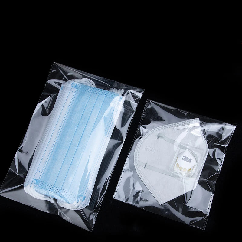 A clear plastic bag containing a disposable light blue face mask and a white surgical mask.