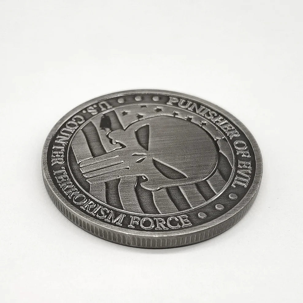 A round, dark silver commemorative coin featuring a stylized two-gun design and text related to terrorism force.