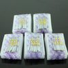 A multi-pack of universal household sewing machine needles in clear plastic packaging with purple tips.