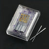 A clear plastic box containing a multi-pack of sewing machine needles with purple markings and a silver pair of tweezers.