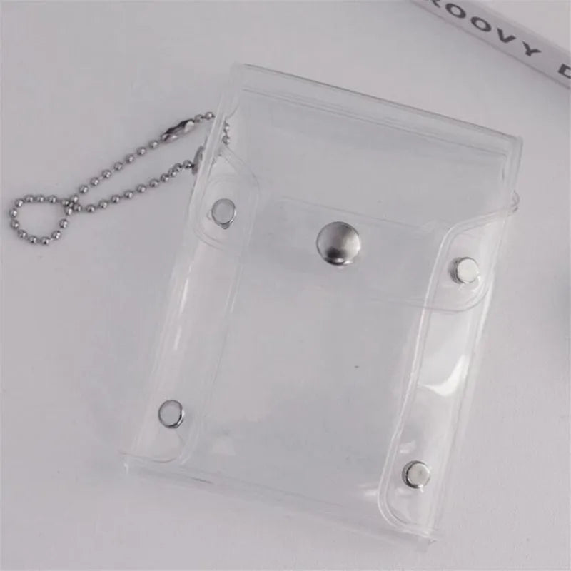 A clear PVC card holder with a silver stud and a beaded chain is displayed on a white surface.