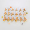 A collection of brass BSP tee pipe fittings for various connections, arranged on a light surface.