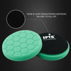 A green hexagonal foam buffing pad with a black backing, demonstrating strong adhesion for tools.
