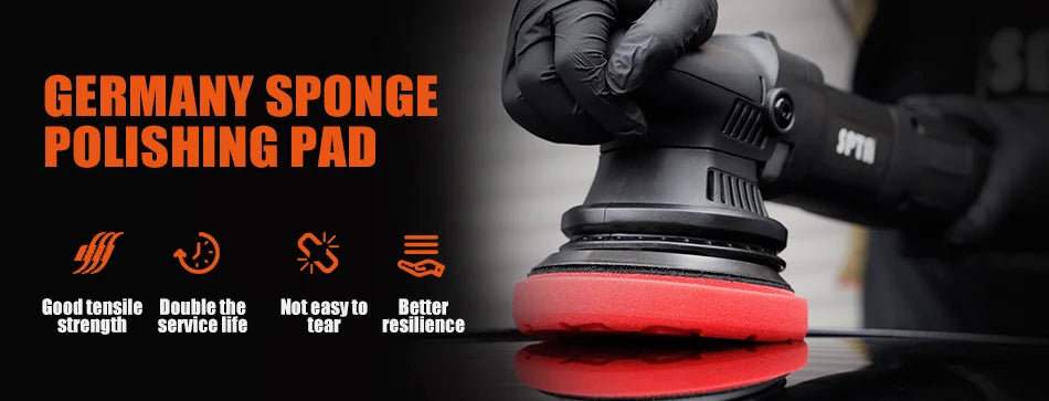 A hand wearing a black glove is polishing a red sponge pad on a black surface.